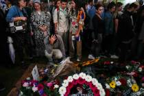 Mourners gather around the grave of Israeli reserve soldier Master sergeant Raz Abulafia at the ...