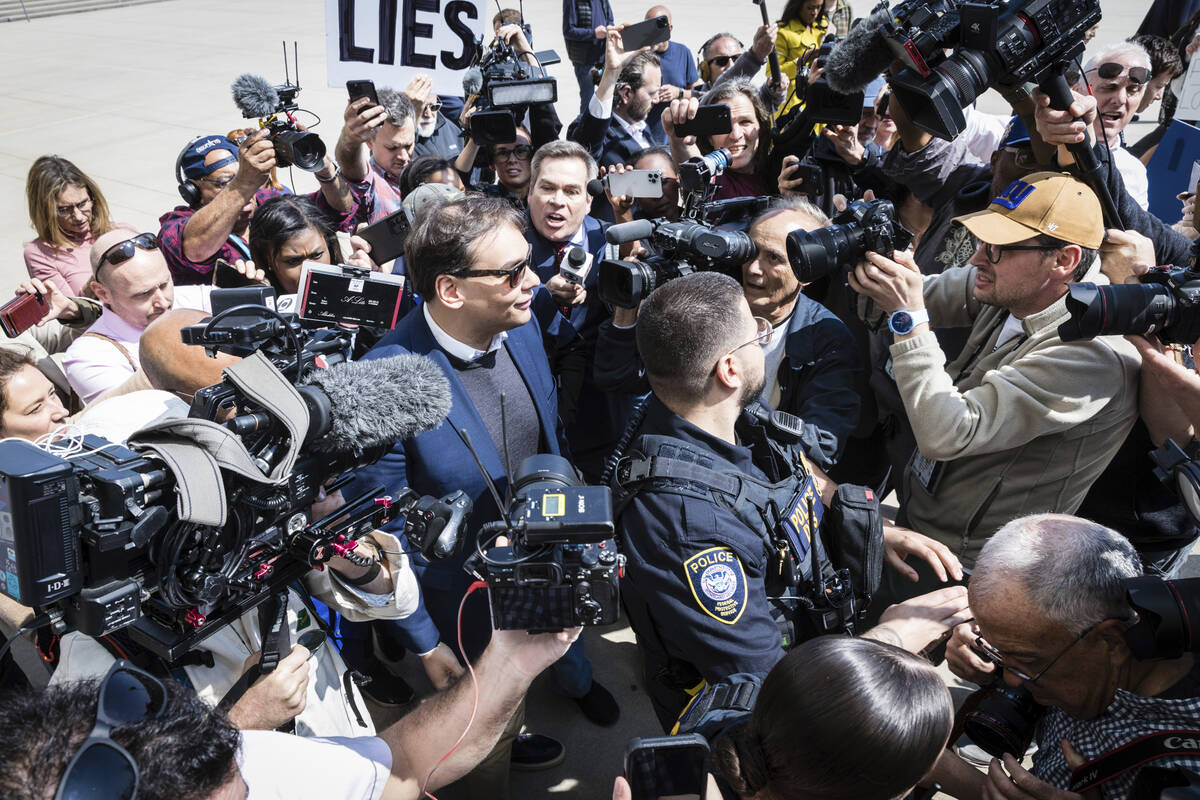 FILE - Rep. George Santos, D-N.Y., speaks to reporters as he leaves the federal courthouse in C ...