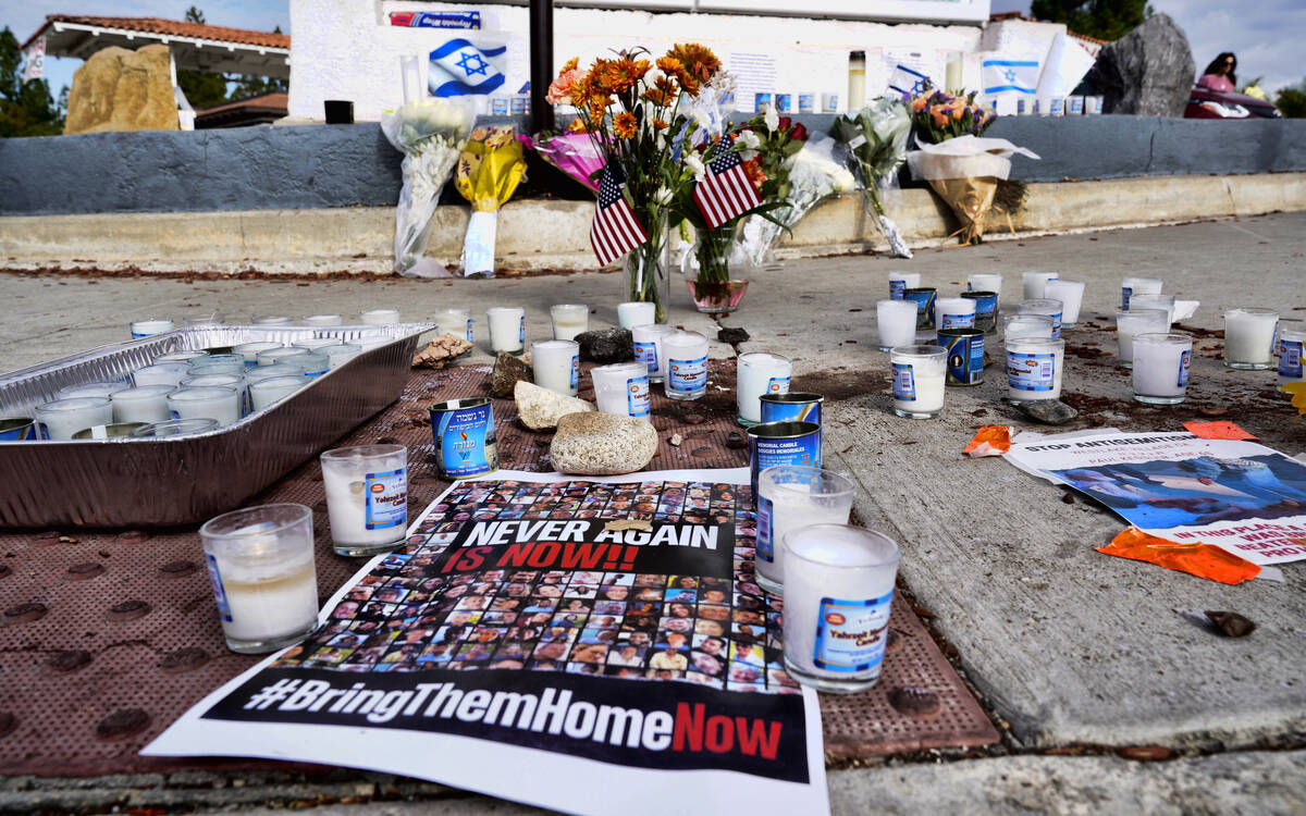 Flowers and candles are left at a makeshift shrine placed at the scene of a Sunday confrontatio ...
