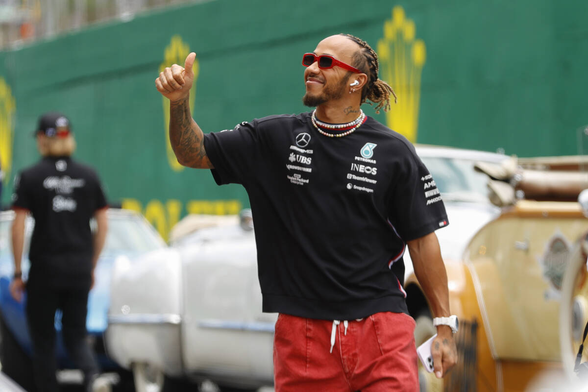 Mercedes driver Lewis Hamilton of Britain greets fans during the opening parade of the Brazilia ...