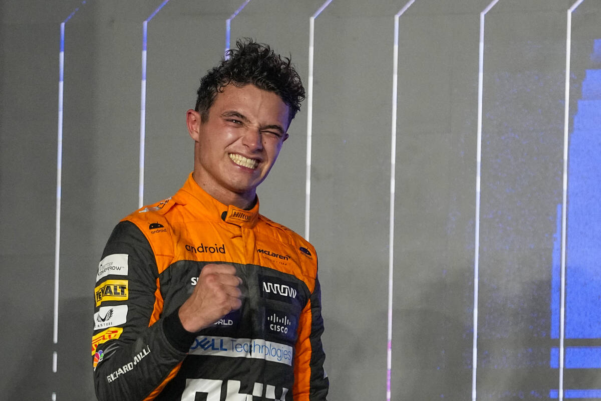 Third placed McLaren driver Lando Norris of Britain celebrates on the podium after the Qatar Fo ...