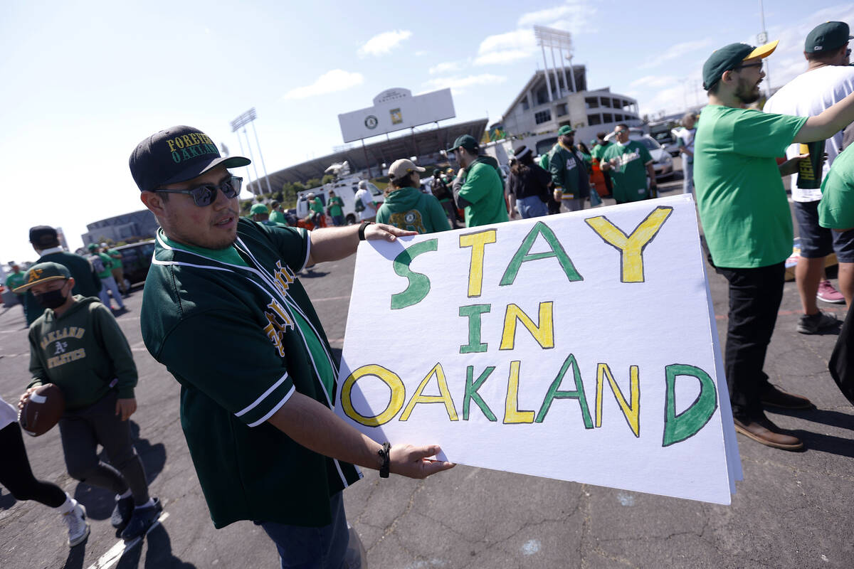 Reuben Ortiz of Modesto, Calif., holds a sign outside Oakland Coliseum to protest the Oakland A ...