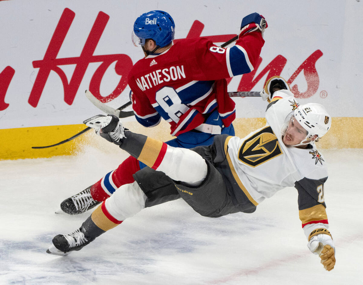 Vegas Golden Knights' Brett Howden (21) is upended by Montreal Canadiens' Mike Matheson (8) dur ...
