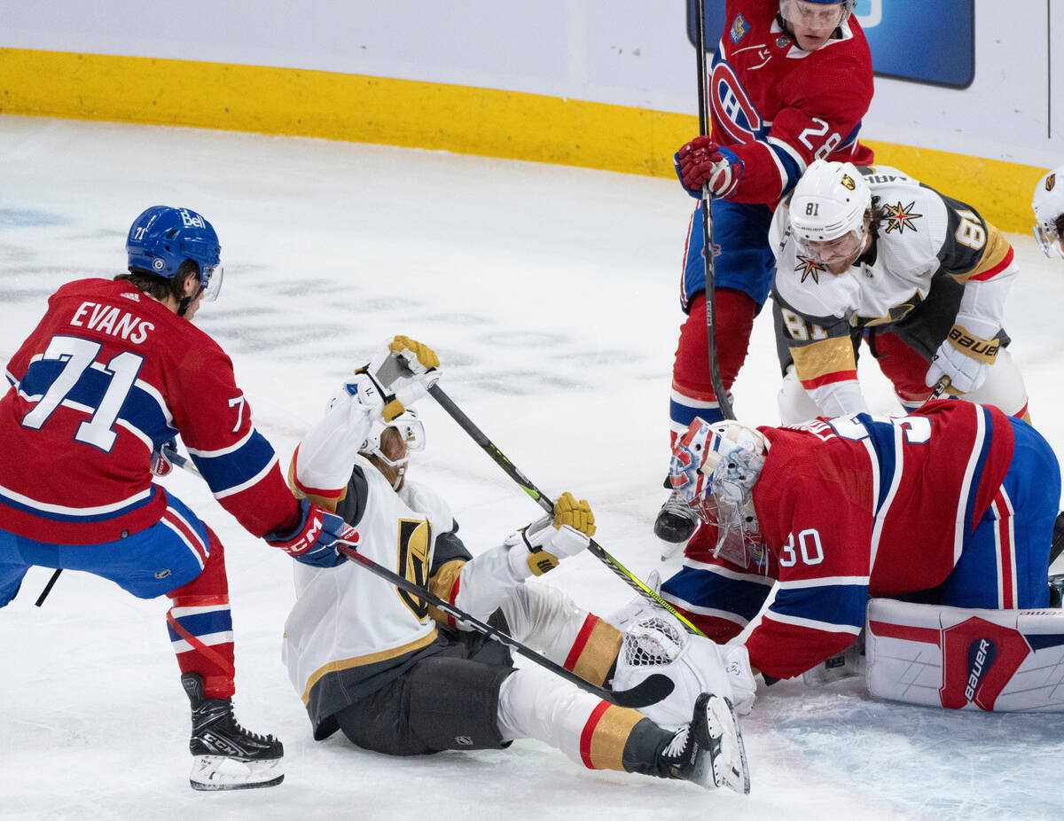 Montreal Canadiens goaltender Cayden Primeau (30) covers the puck as Vegas Golden Knights' Will ...