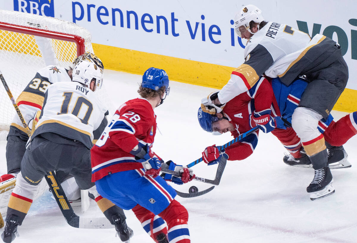 Vegas Golden Knights' Alex Pietrangelo (7) drops Montreal Canadiens' Brendan Gallagher (11) beh ...
