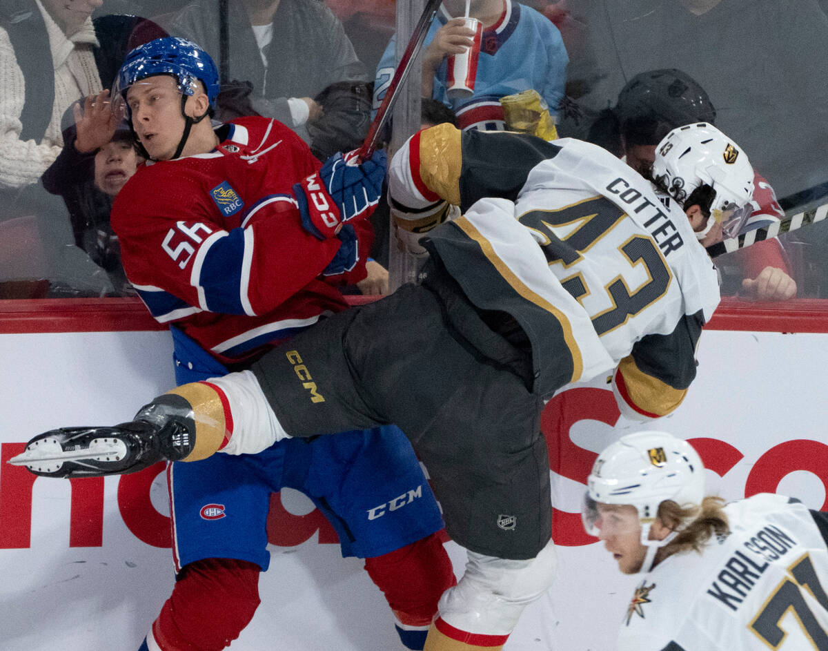 Montreal Canadiens' Jesse Ylonen (56) is checked into the boards by Vegas Golden Knights' Paul ...