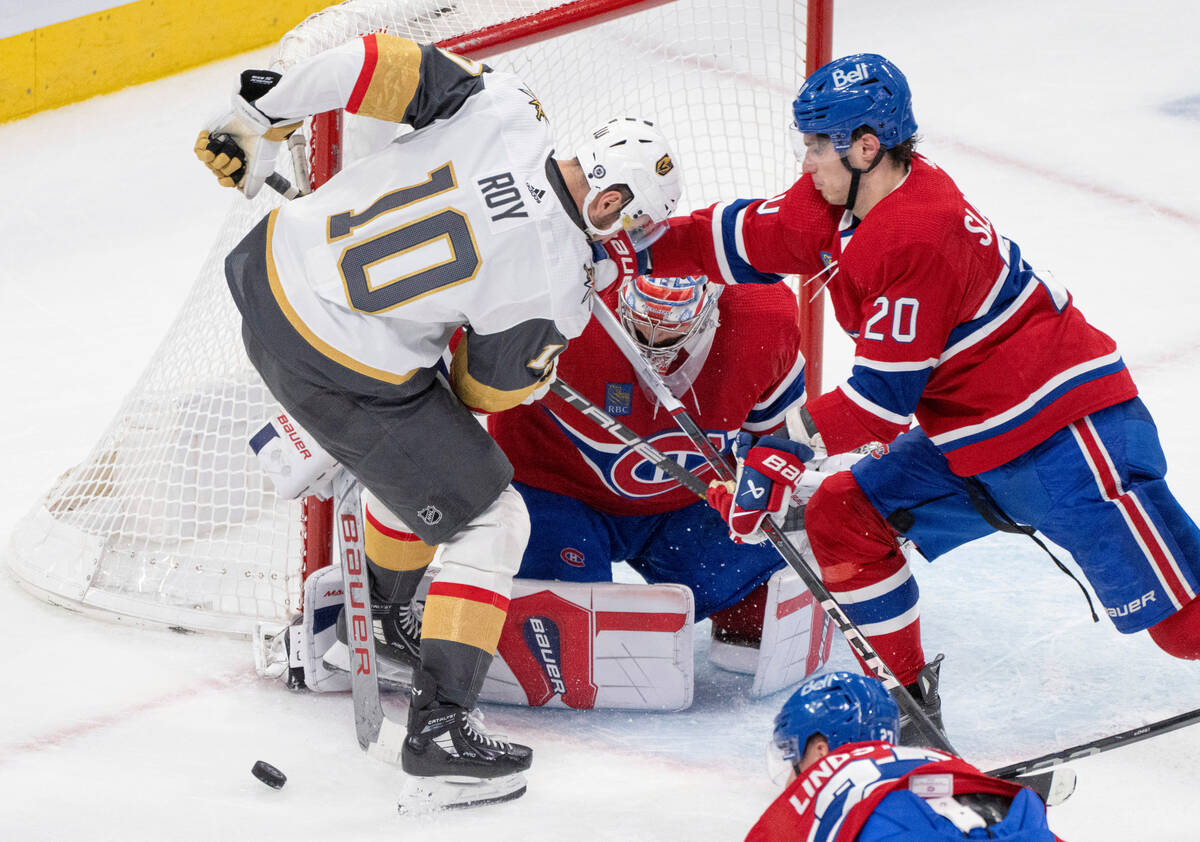 Vegas Golden Knights' Nicolas Roy (10) and Montreal Canadiens' Juraj Slafkovsky (20) vie for a ...