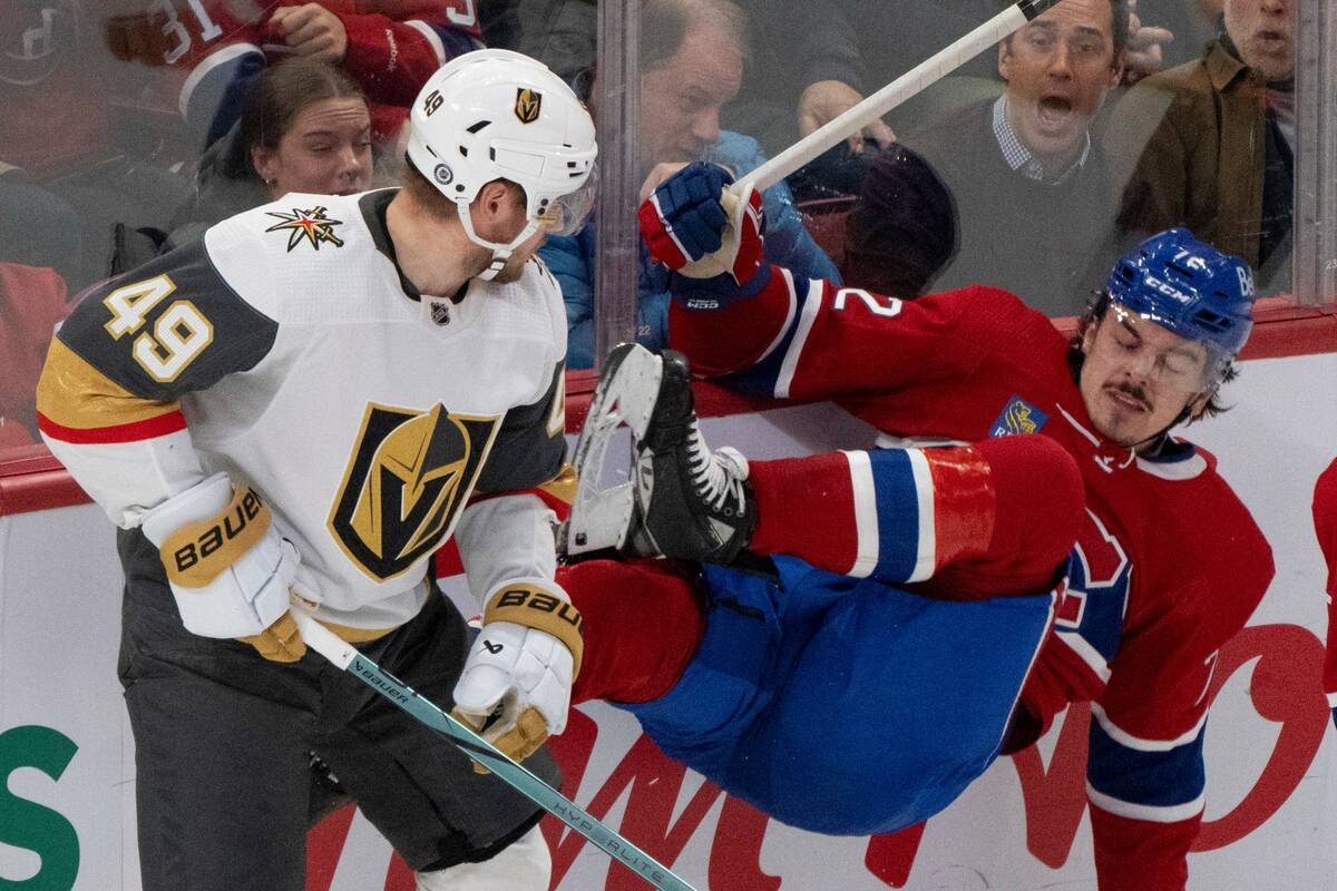 Montreal Canadiens' Arber Xhekaj (72) is checked into the boards by Vegas Golden Knights' Ivan ...
