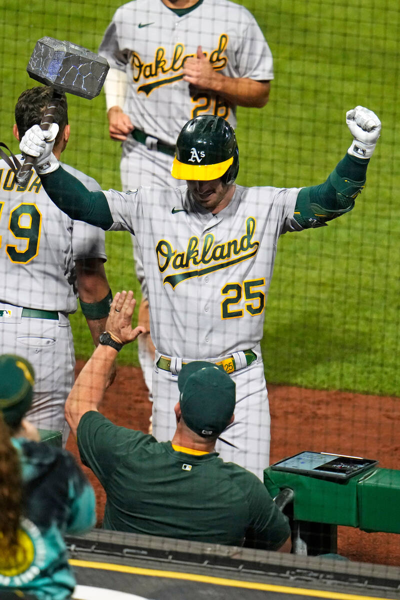 Oakland Athletics' Brent Rooker (25) celebrates as he returns to the dugout after hitting a two ...