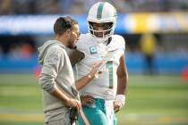 Miami Dolphins quarterback Tua Tagovailoa (1) talks to head coach Mike McDaniel during an NFL f ...