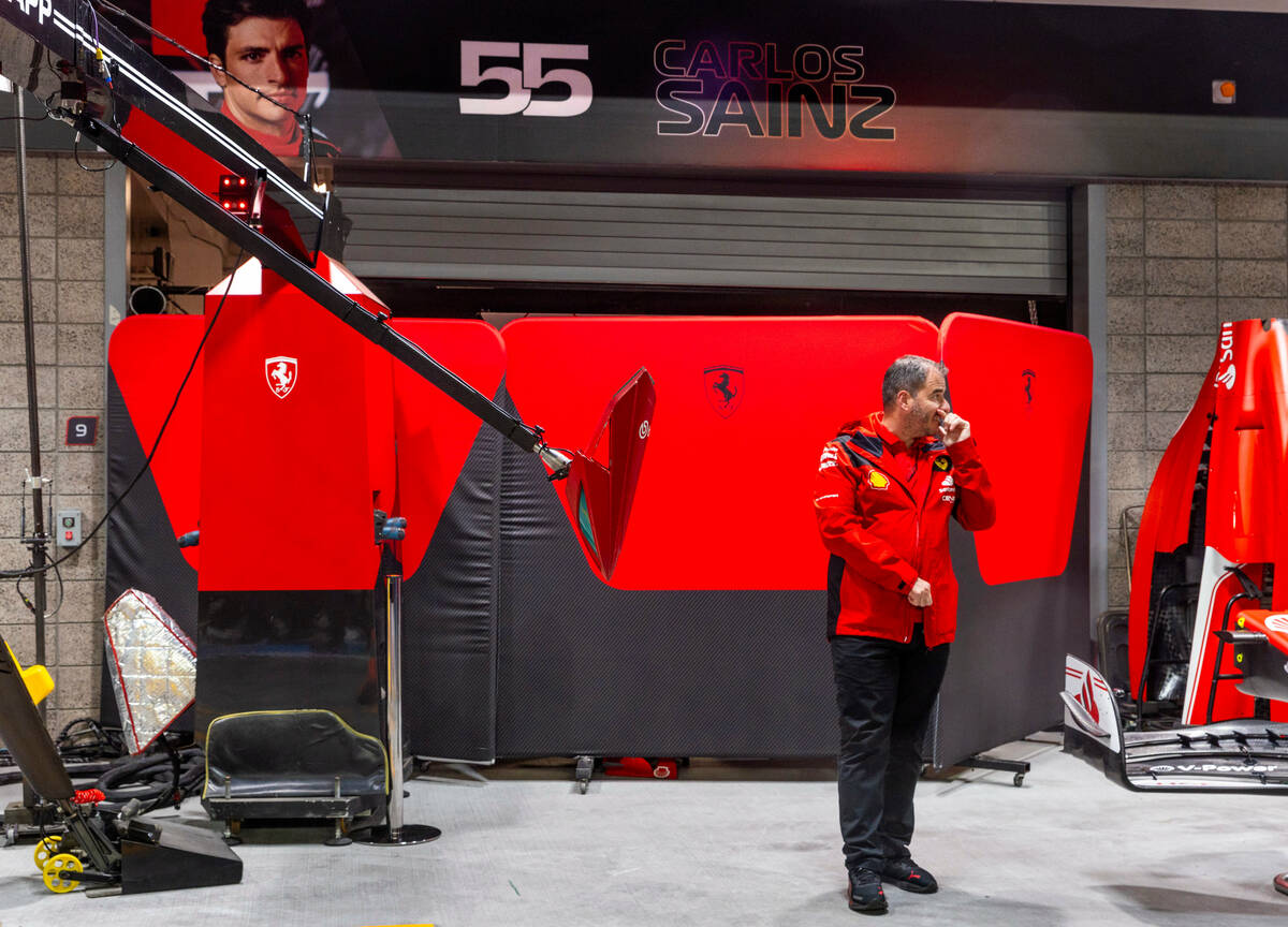 The car of Carlos Sainz with Ferrari is worked on behind barriers after it was damaged on the t ...