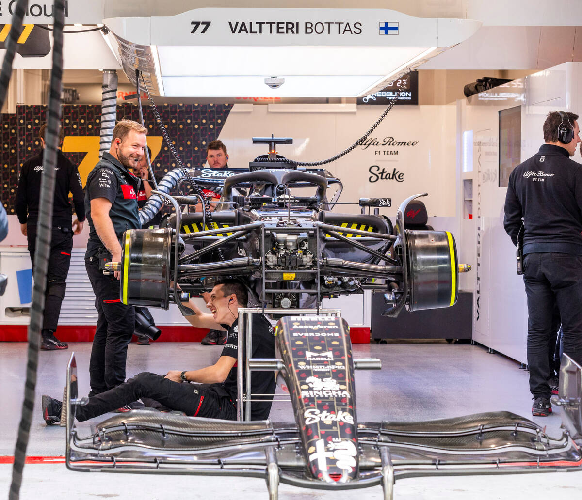 A crew from Valtteri Bottas of Alpha Romero work to make repairs in the pit building during the ...