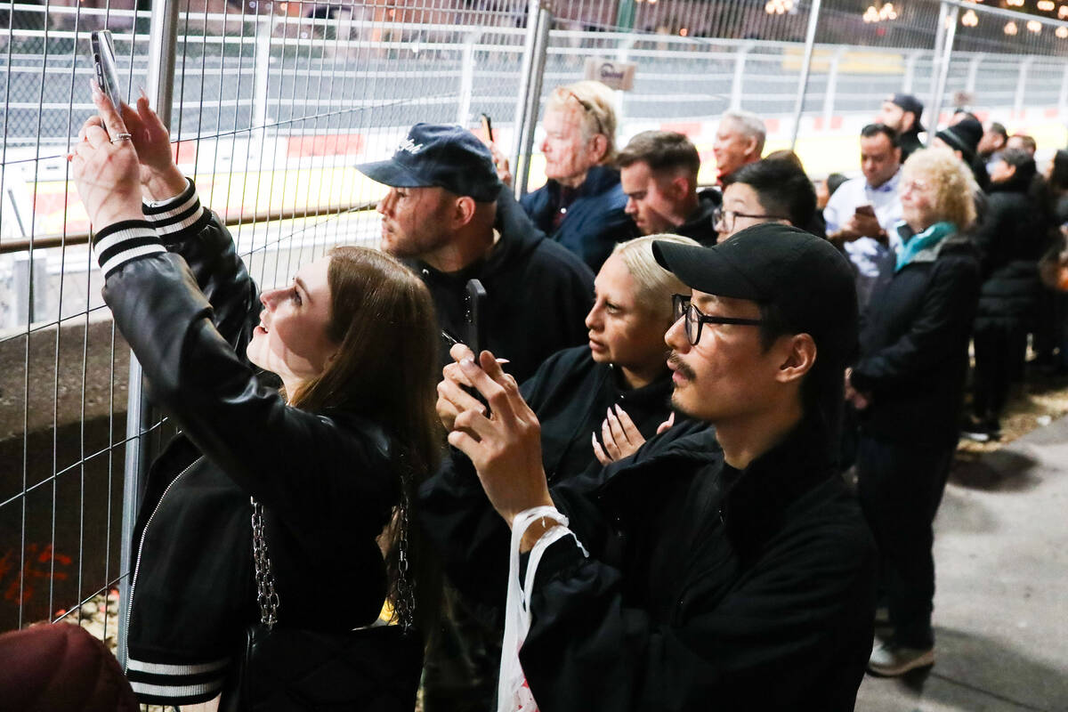 Tourists to the Strip watch the first practice race for the Formula 1 Las Vegas Grand Prix on T ...