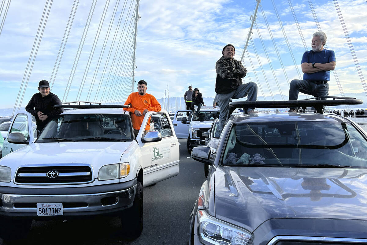Motorists wait in a queue as demonstrators shut down the San Francisco Oakland Bay Bridge in co ...