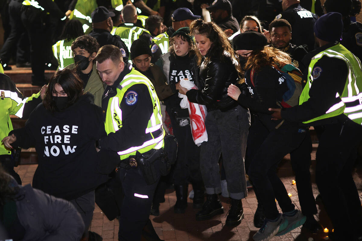 Members of U.S. Capitol Police lead protesters away from the headquarters of the Democratic Nat ...