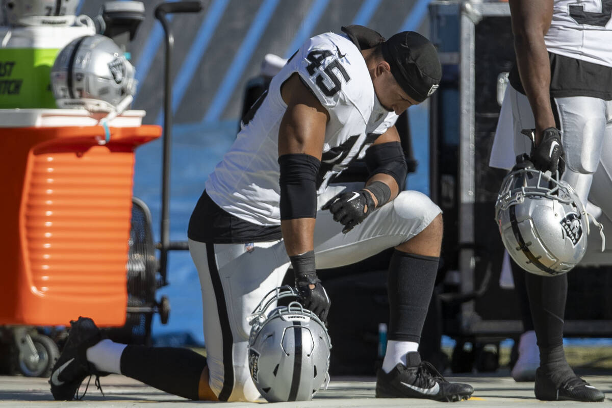 Raiders fullback Jakob Johnson (45) bows his head on the sideline during the second half an NFL ...