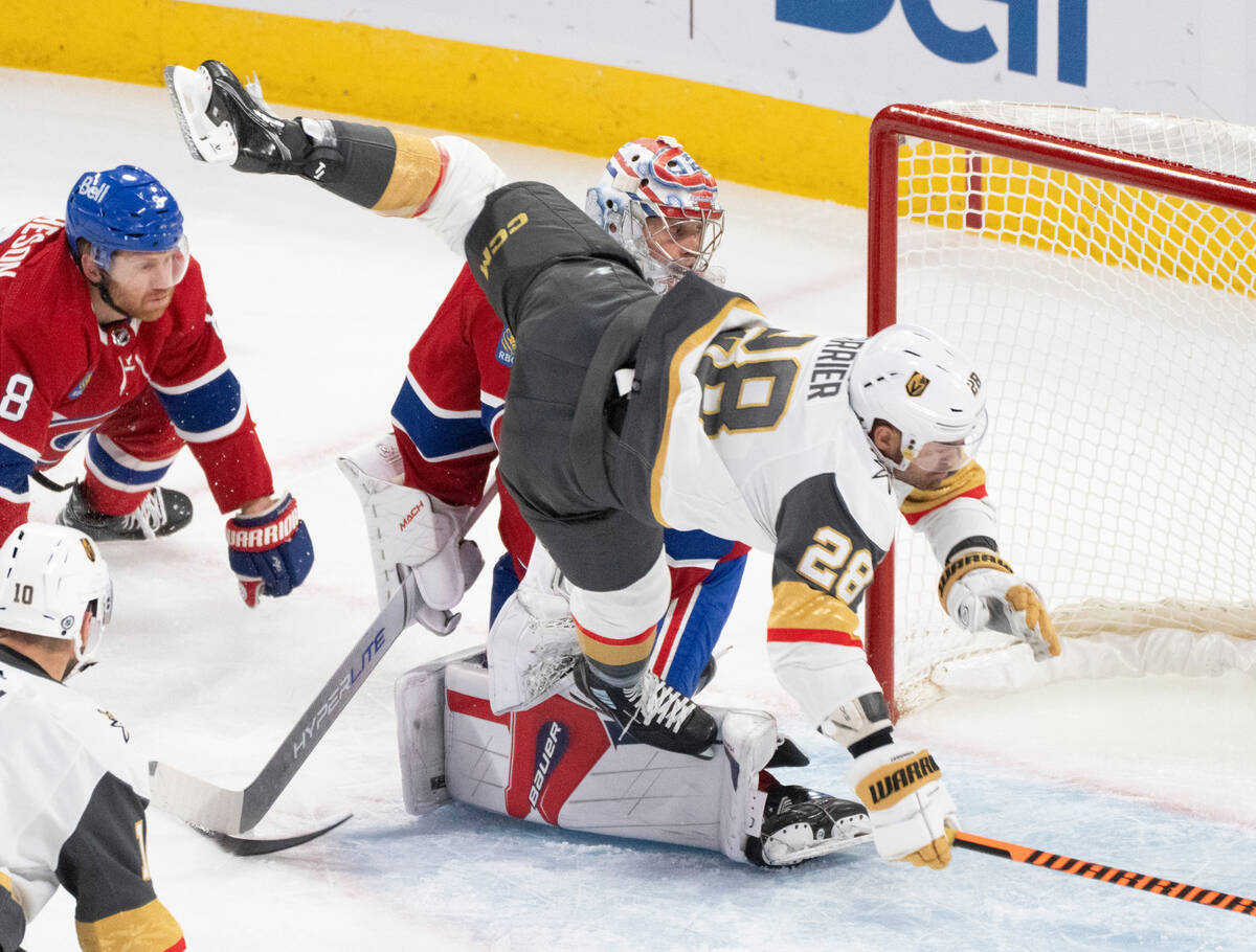 Vegas Golden Knights' William Carrier (28) is tripped in front of Montreal Canadiens goaltender ...