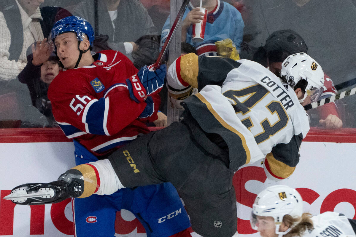 Montreal Canadiens' Jesse Ylonen (56) is checked into the boards by Vegas Golden Knights' Paul ...