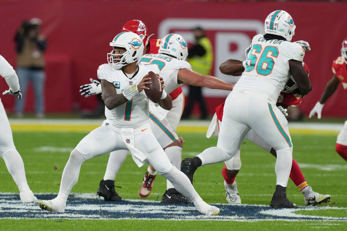 Miami Dolphins quarterback Tua Tagovailoa (1) looks to pass during the first half of an NFL foo ...