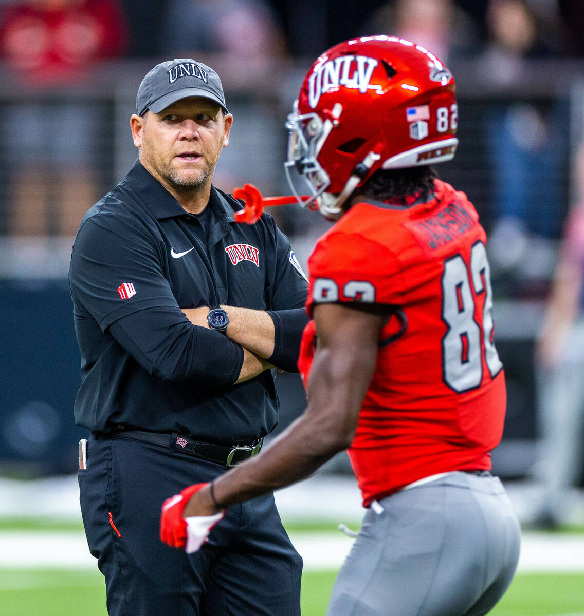 UNLV Head Coach Barry Odom speaks to wide receiver Rashawn Jackson (82) in warmups before the f ...
