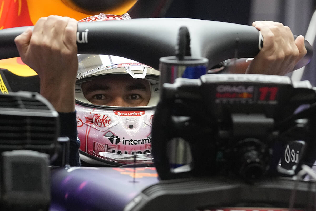 Red Bull driver Sergio Perez, of Mexico, gets into his car during the final practice session fo ...