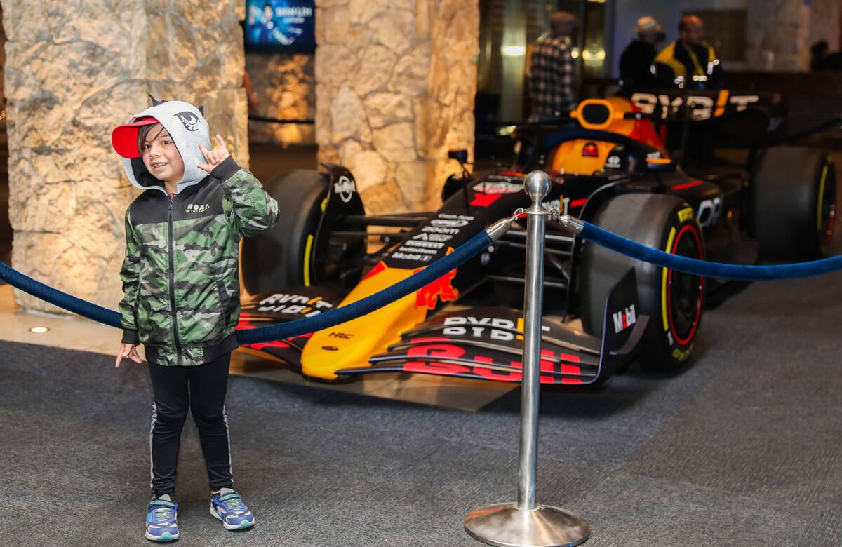 Max Espinosa poses for a picture in front of a Red Bull Racing Formula 1 race car prior to the ...