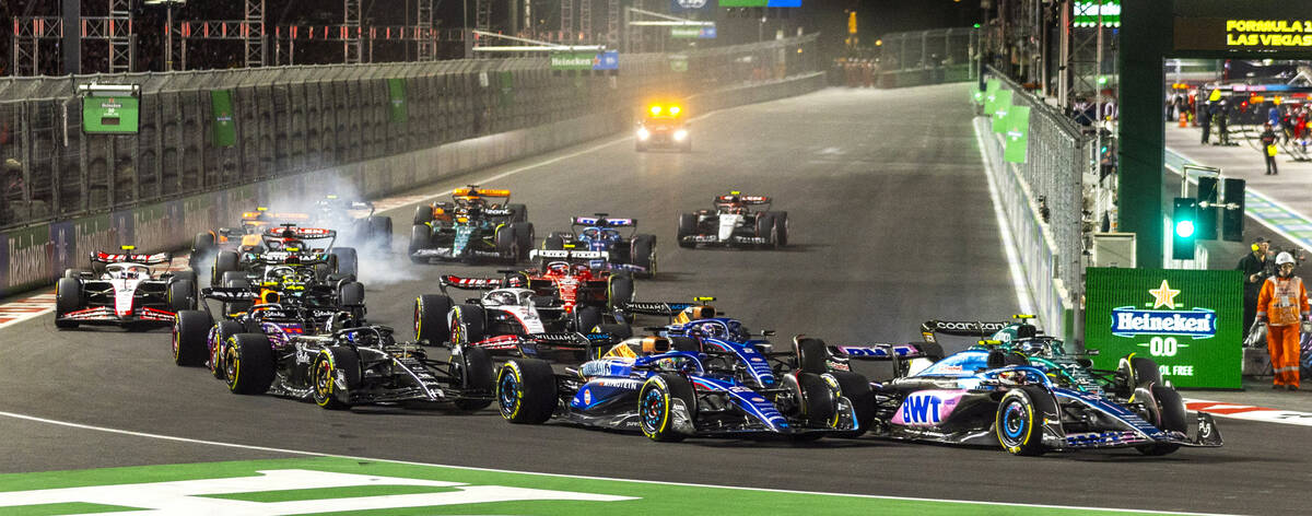 Cars bunch up into turn one at the start of the Las Vegas Grand Prix Formula One race on Saturd ...