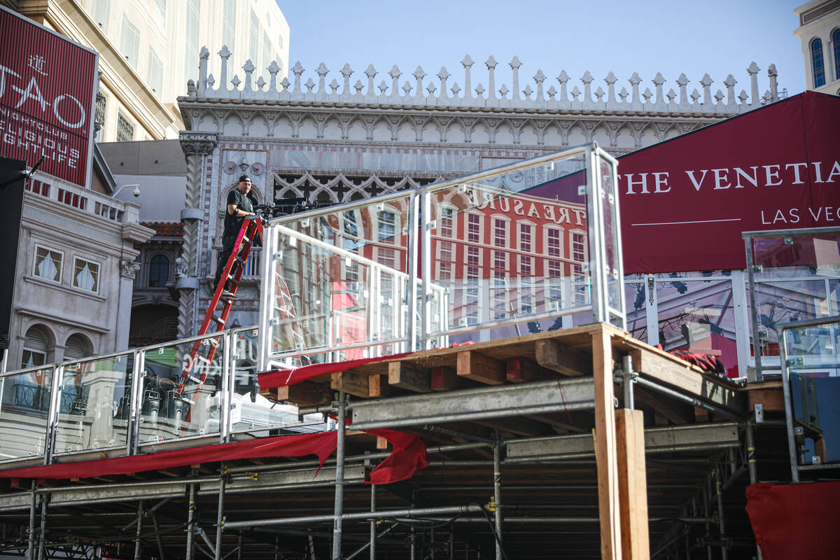 Workers disassemble a stage that was for entertaining guests of the Formula 1 Las Vegas Grand P ...
