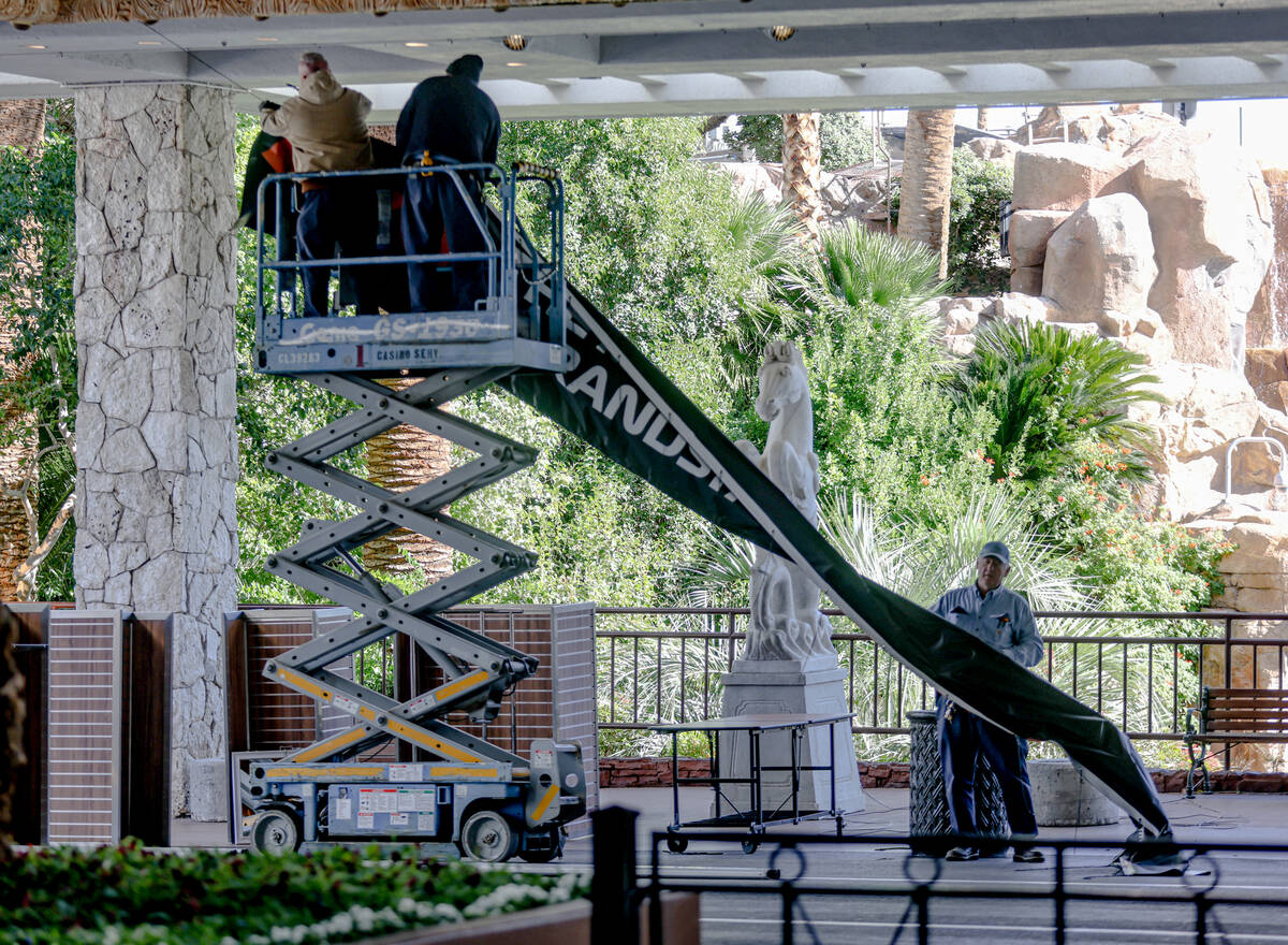 Workers disassemble signage for the Formula 1 Las Vegas Grand Prix race on the Strip in Las Veg ...