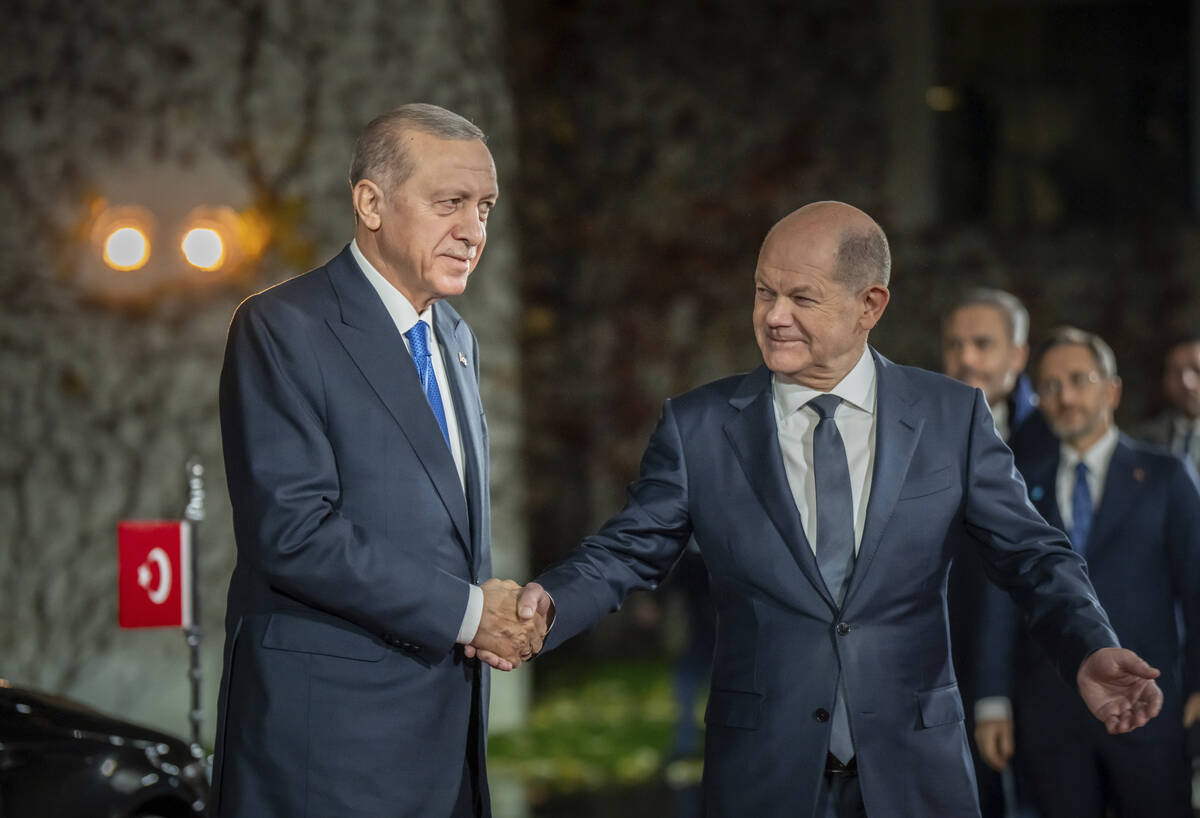German Chancellor Olaf Scholz, right, shakes hands with Turkish President Recep Tayyip Erdogan ...
