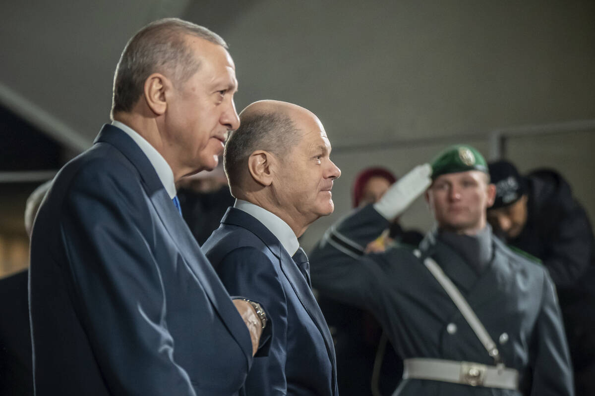 German Chancellor Olaf Scholz, centre, receives Turkish President Recep Tayyip Erdogan, left, a ...