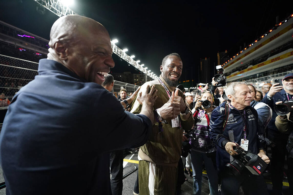 Usain Bolt, right, jokes with actor Terry Crews at the Formula One Las Vegas Grand Prix auto ra ...