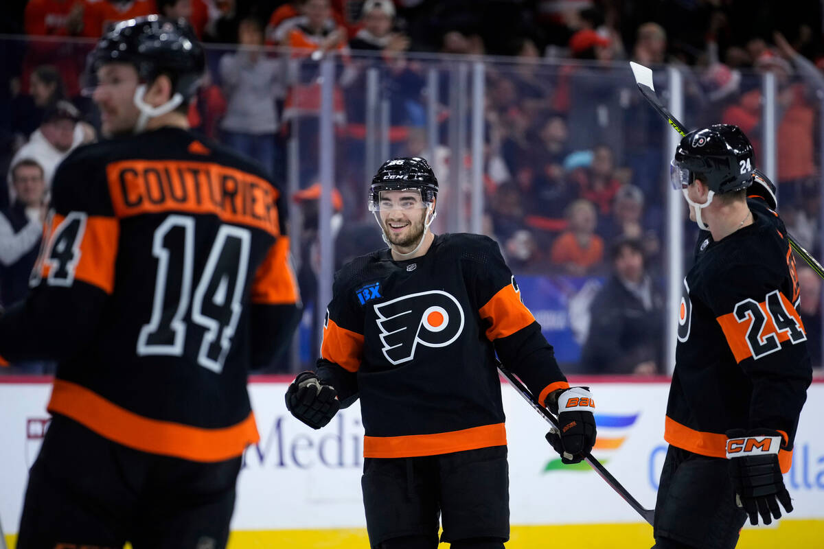 Philadelphia Flyers' Sean Walker, center, celebrates with Nick Seeler, right, and Sean Couturie ...