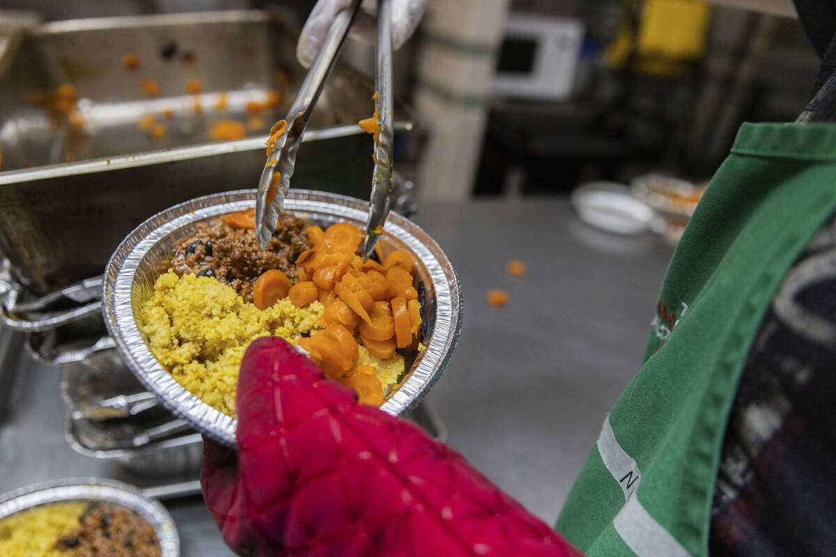 A volunteer prepares a lunch box at Community Help in Park Slope, a soup kitchen and food pantr ...