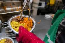 A volunteer prepares a lunch box at Community Help in Park Slope, a soup kitchen and food pantr ...