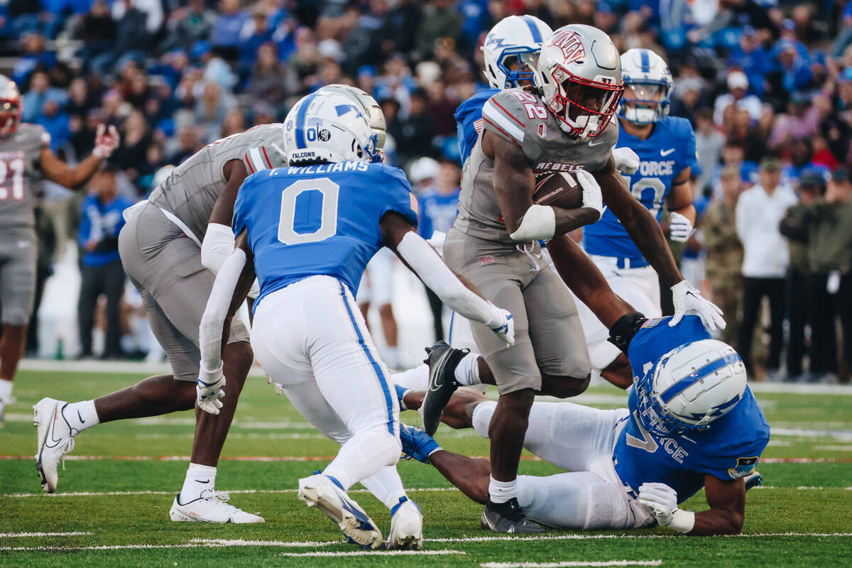 UNLV running back Jai'Den Thomas (22) runs the ball past Air Force defenders during a game at F ...