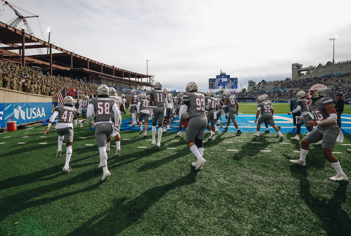 UNLV players take to the field before a game against Air Force at Falcon Stadium on Saturday, N ...