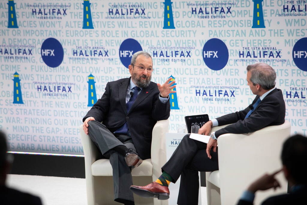 Former Israeli prime minister Ehud Barak (left) speaks with PBS correspondent Nick Schifrin at ...