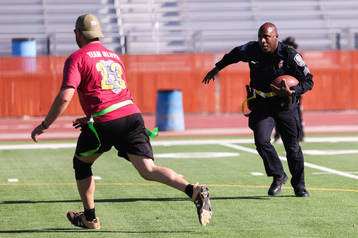 Sergeant Marcus Cook runs the ball down the field during the third annual Turkey Bowl between L ...