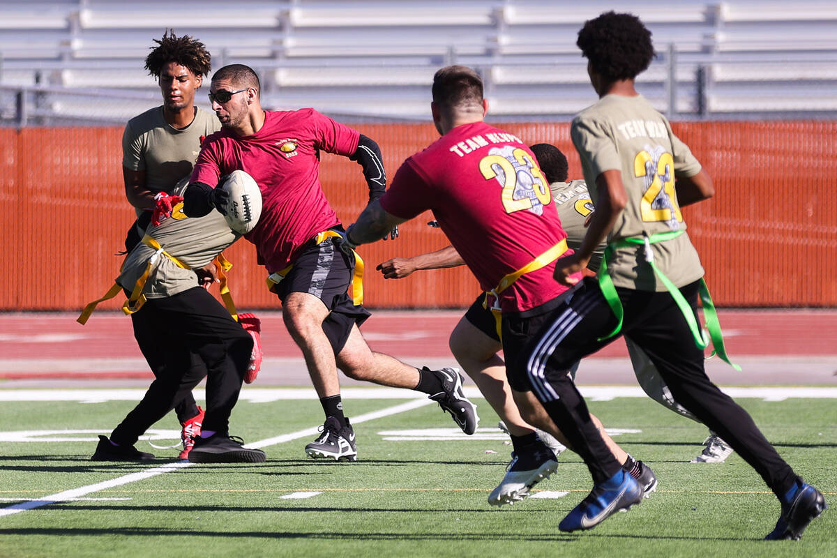 Michael Glenn, North Las Vegas corrections officer, runs the ball down the field during the thi ...