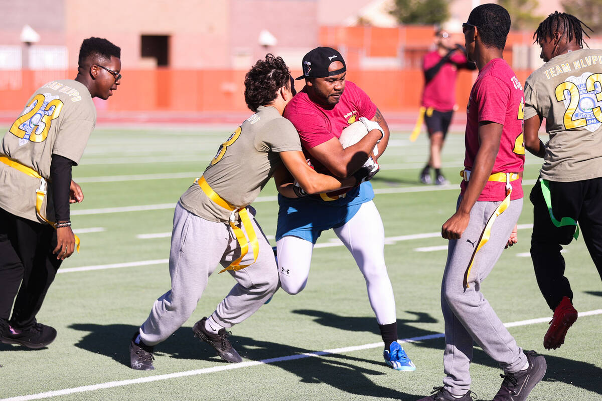 Anthony Bajalia, North Las Vegas police officer, is nearly tackled by Isaiah Colbert, a Coronad ...