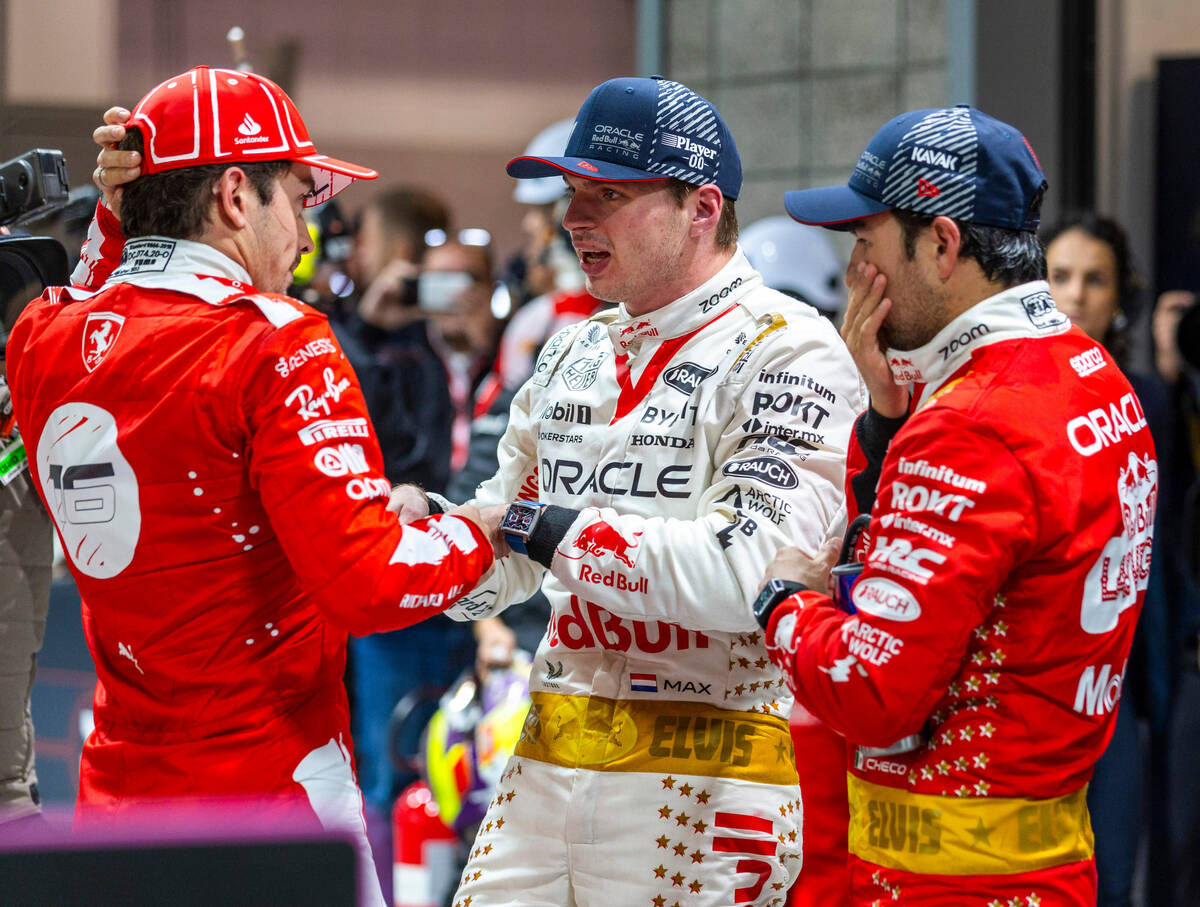 Ferrari driver Charles Leclerc, left, talks with Red Bull Racing driver Max Verstappen and team ...