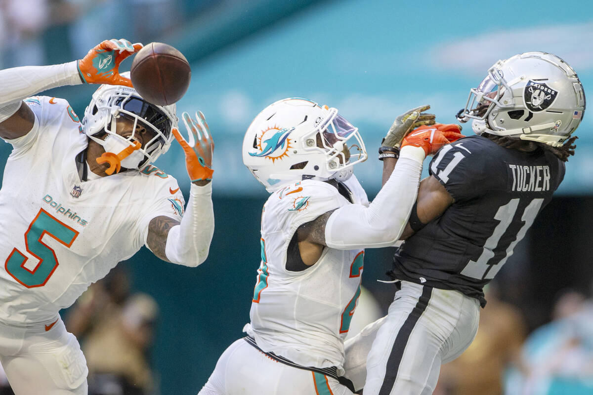 Miami Dolphins cornerback Jalen Ramsey (5) intercepts the football with safety DeShon Elliott ( ...
