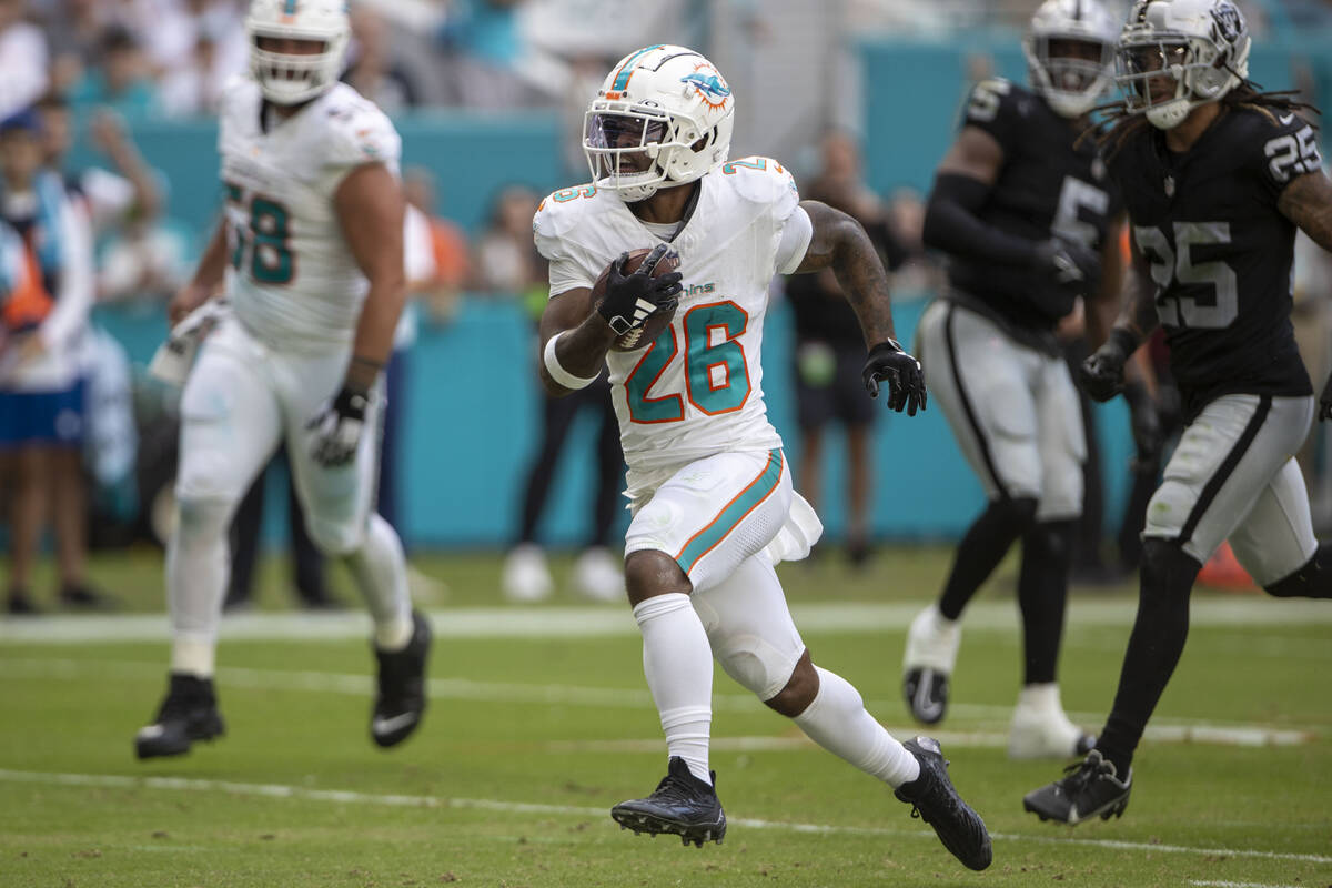 Miami Dolphins running back Salvon Ahmed (26) runs for a touchdown during the first half of an ...