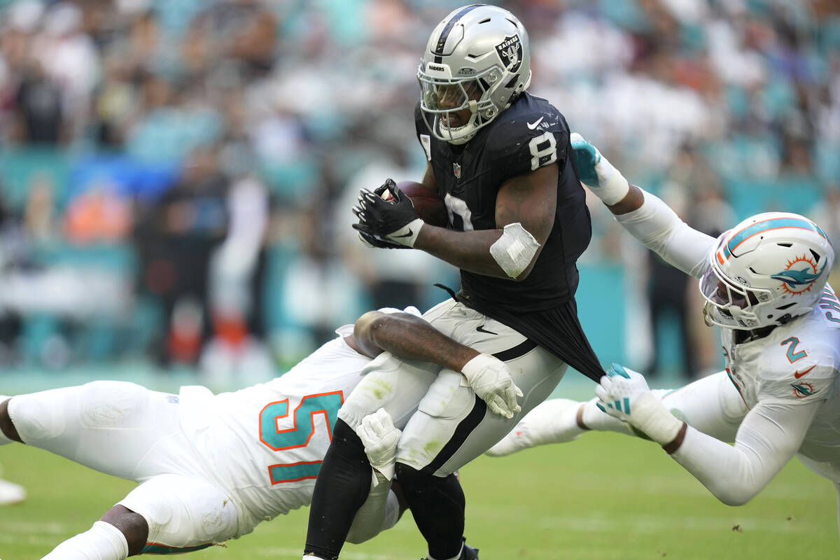 Miami Dolphins linebackers David Long Jr. (51) and Bradley Chubb (2) tackle Las Vegas Raiders r ...