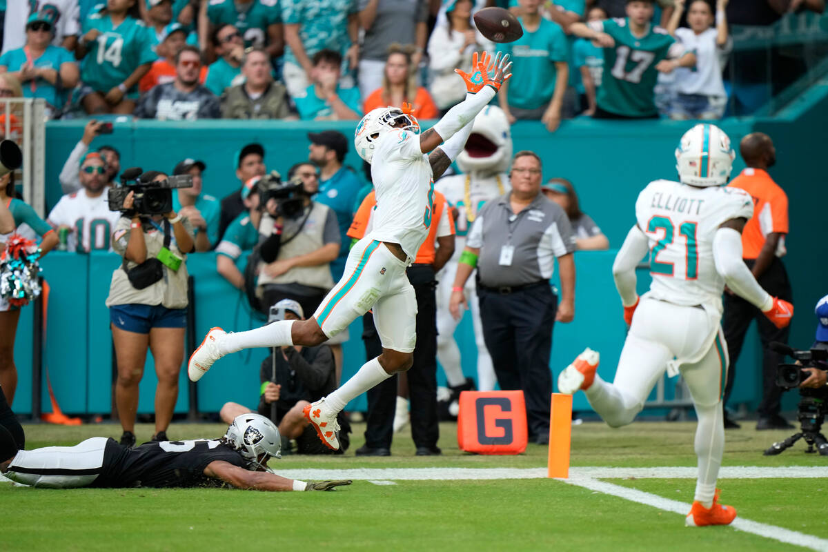 Miami Dolphins cornerback Jalen Ramsey (5) attempts to intercept a pass intended for Las Vegas ...