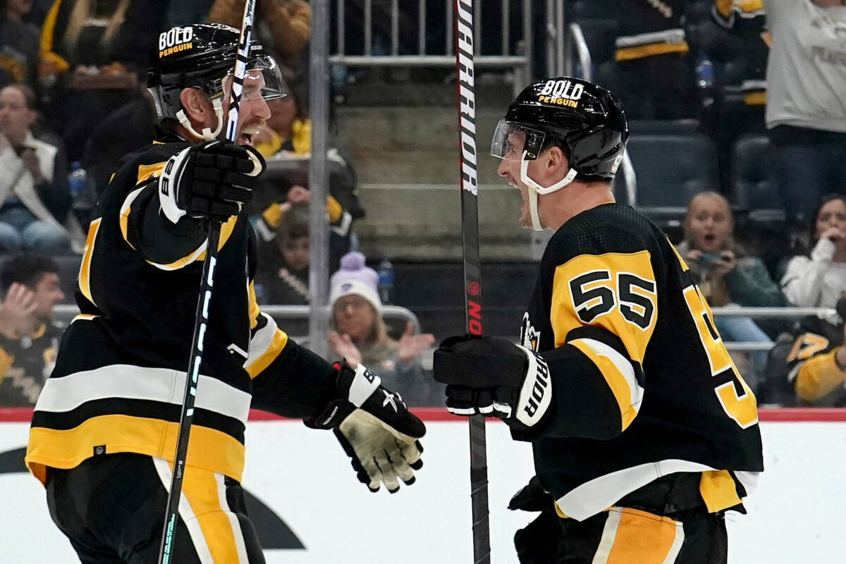 Pittsburgh Penguins' Noel Acciari (55) is congratulated by Jeff Carter, left, after scoring aga ...