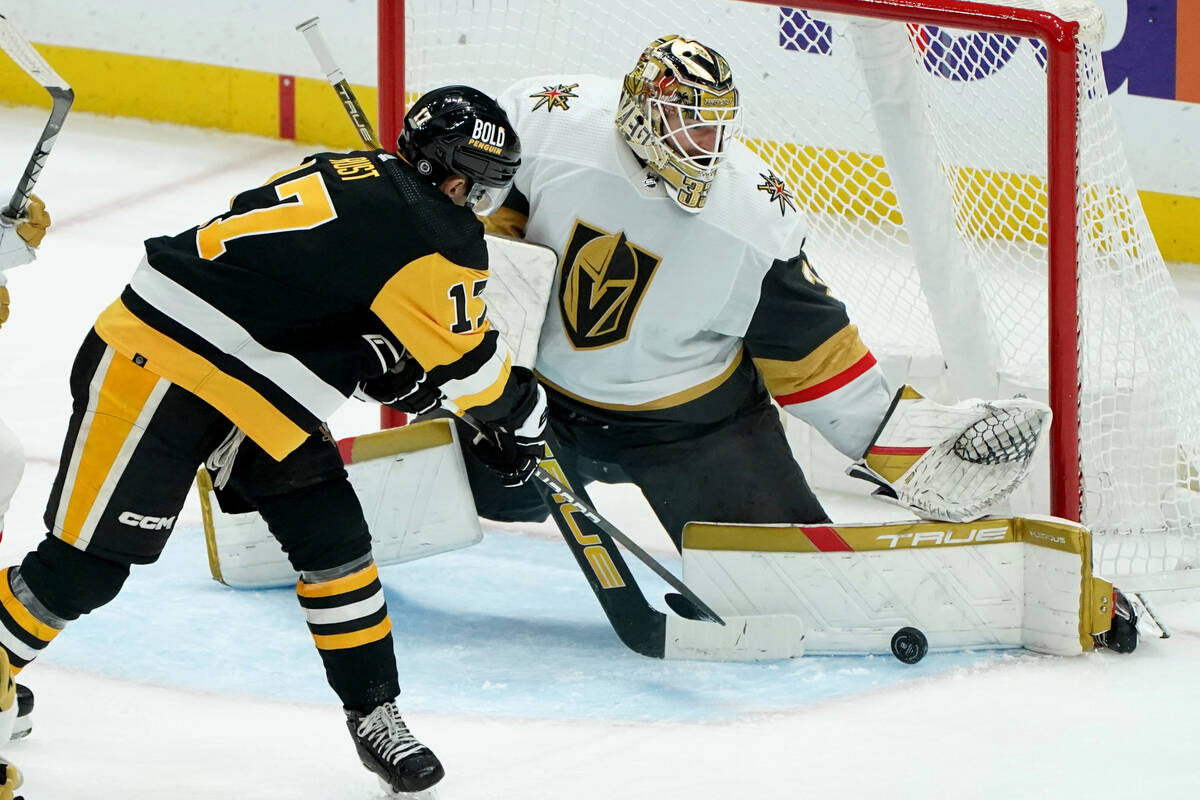 Vegas Golden Knights goaltender Adin Hill makes a save on Pittsburgh Penguins' Bryan Rust durin ...
