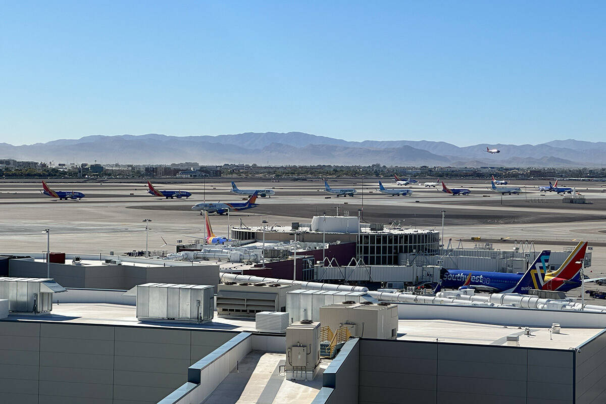 A line of planes wait to depart from Harry Reid International Airport around noon on Sunday, No ...