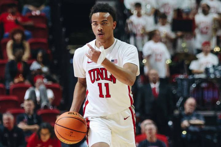 UNLV guard Dedan Thomas Jr. (11) signals to a teammate as he dribbles the ball down the court d ...